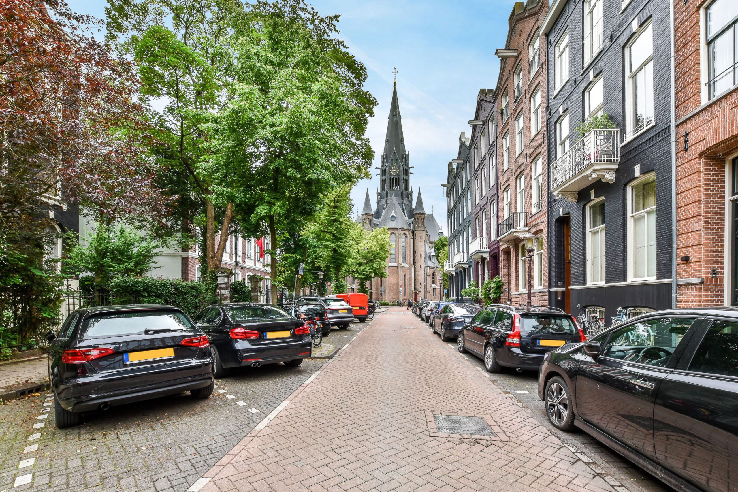 Street with residential buildings and parked cars